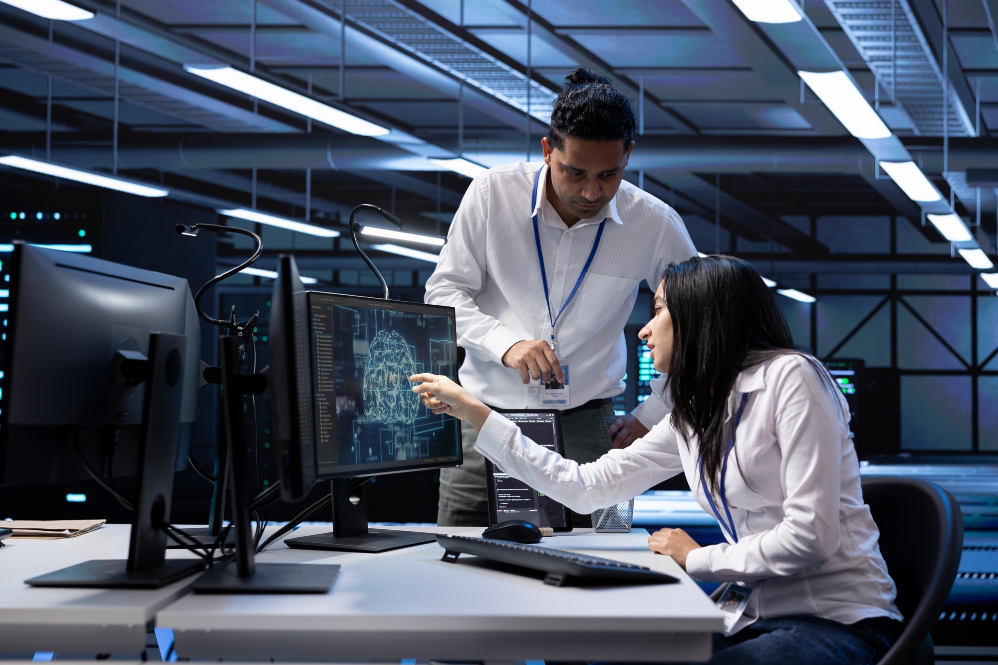 Teamworking employees inspecting neural network data center