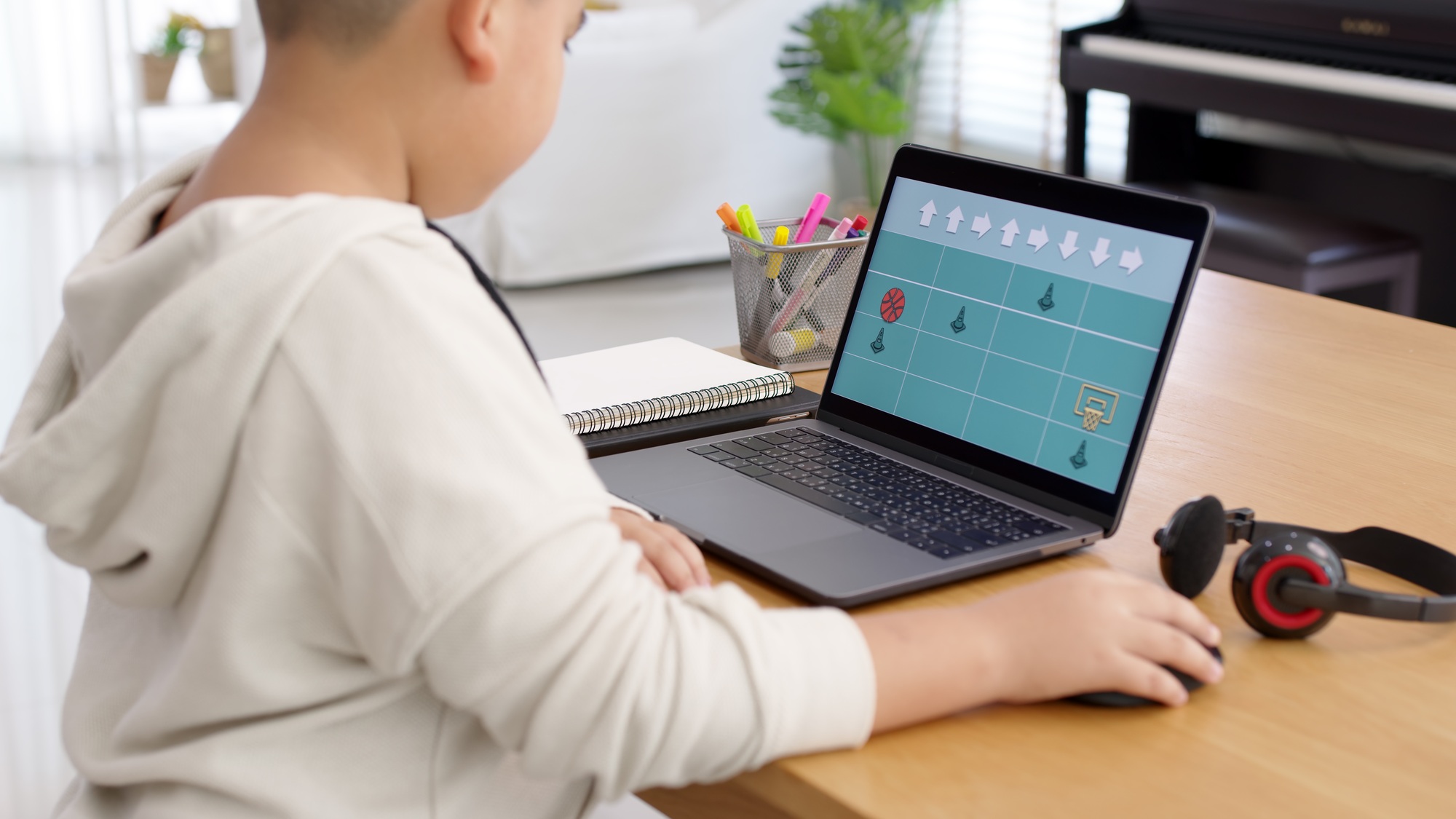 Young asia student kid remotely learn online at home in unplugged coding